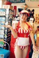 A woman in a red and white striped bathing suit posing for a picture.