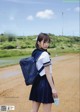 A woman in a school uniform with a backpack and money.